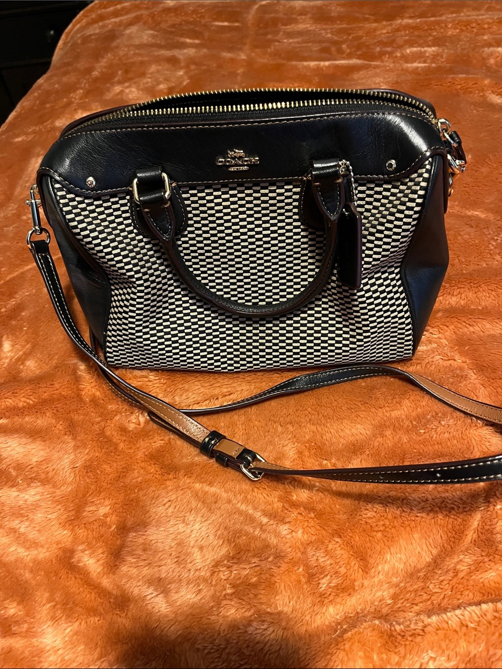 Coach mini bennett satchel with black and tan exploded pattern.